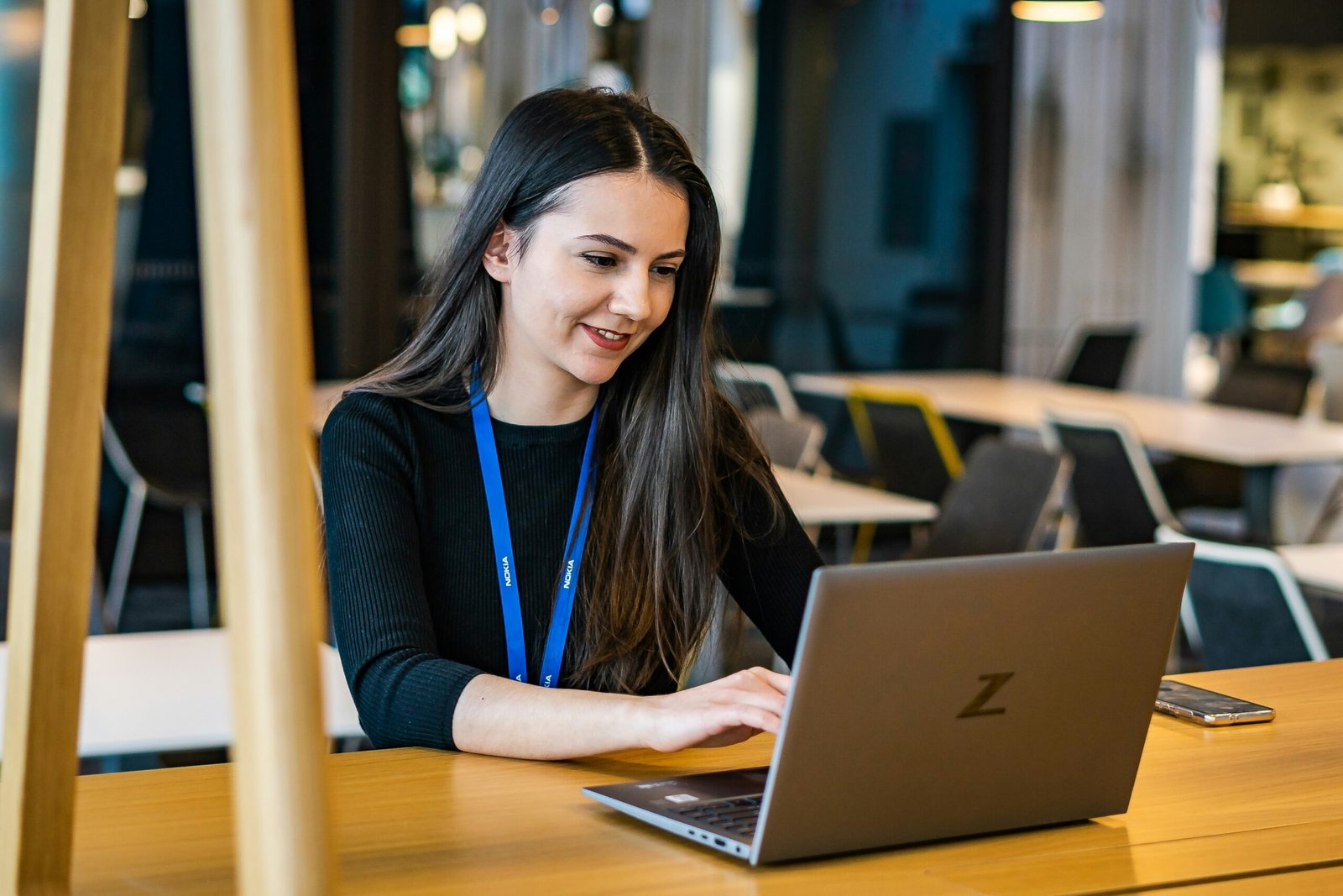 Business professional working on a laptop in a modern office environment